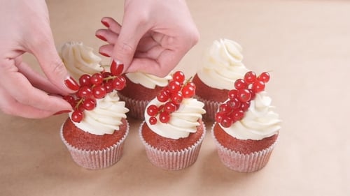 Cupcakes Garnished with Frosting and Currant Berries