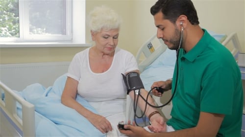 Doctor Checking Blood Pressure of Senior Patient