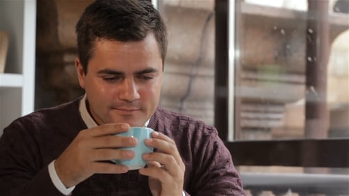 Man Looks Out the Window at the Cafe