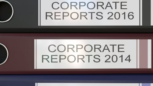 Vertical Stack of Multicolor Office Binders with Corporate Reports Tags Different Years