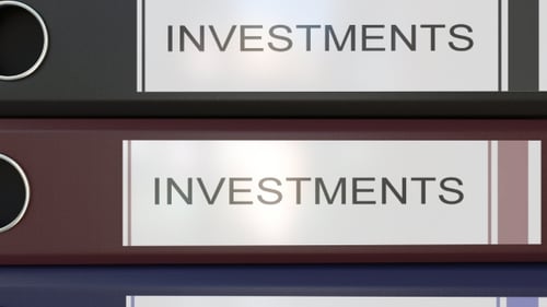 Vertical Stack of Multicolor Office Binders with Investments Tags