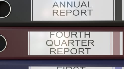Vertical Stack of Multicolor Office Binders with Quarter and Annual Reports Tags