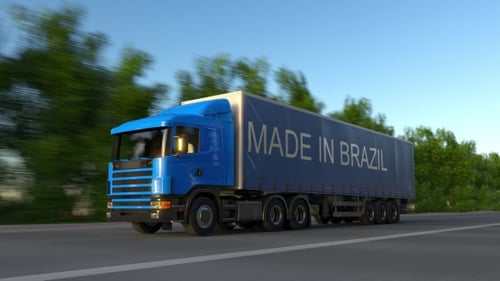 Speeding Freight Semi Truck with MADE IN BRAZIL Caption on the Trailer
