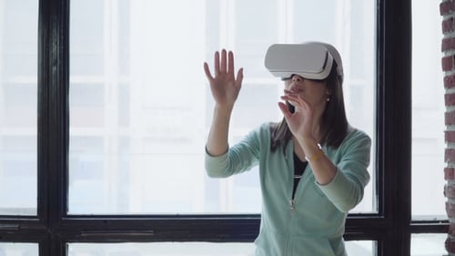 Woman Wearing VR Headset Interacting in Apartment