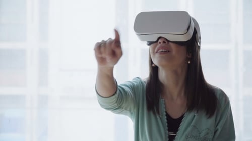 Woman Using Virtual Reality Headset Indoors