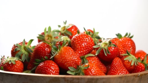 Strawberry in a Wooden Bowl Rotates on a Turntable