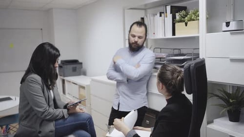 Colleagues discussing business results in office