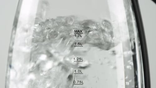 Water Boiling in Clear Electric Kettle Close Up