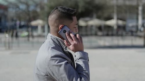 Young Man Talking on Phone Outdoors