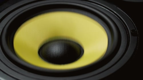 Yellow Speaker Diaphragm Vibrating in Close Up