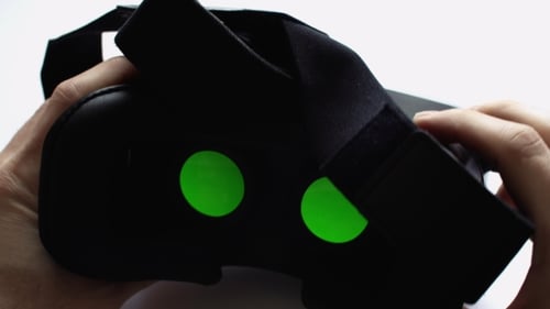 Hands Showcasing Black Virtual Reality Headset