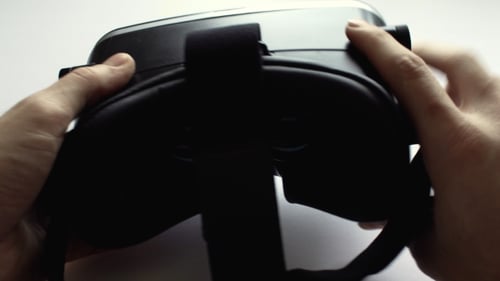 Hands Adjusting Virtual Reality Headset Device