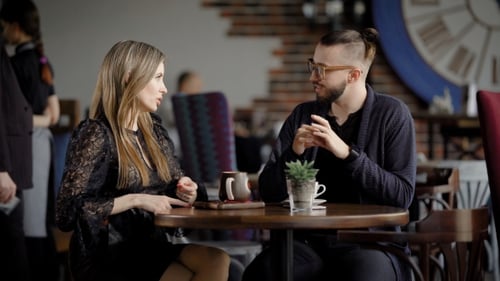Business People at Lunch Break in a Cafe. Two Men and a Woman Talk About Work During Lunch