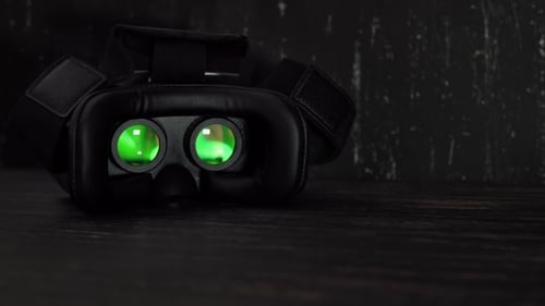 Black VR Headset on Dark Wooden Surface