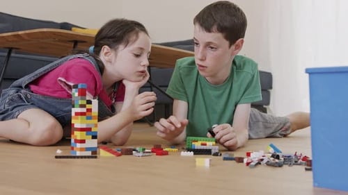 Children Building with Toy Bricks on Living Room Floor
