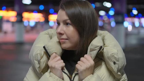 Young Woman Standing and Looking at Camera in Underground Parking Garage