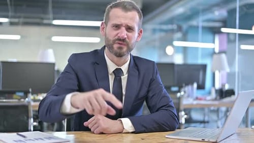 Angry Young Businessman Screaming on Camera in Office