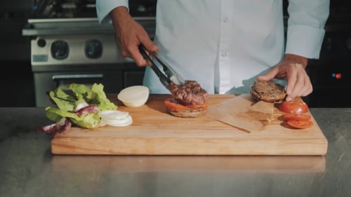 Burger Preparation in Commercial Kitchen by Chef