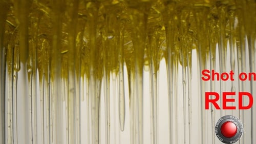 Golden Liquid Dripping Abstractly in Macro Shot