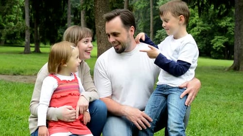 Family Middle Couple in Love, Cute Girl and Small Boy Together Talk in the Park
