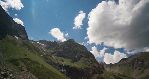 Mountain With Moving Clouds On Blue Sky