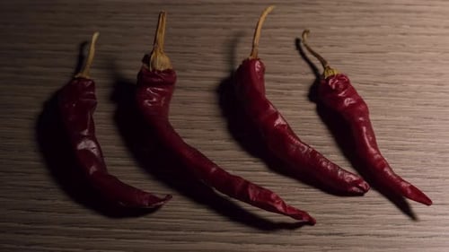 Dried Red Chili Peppers on Wood Surface