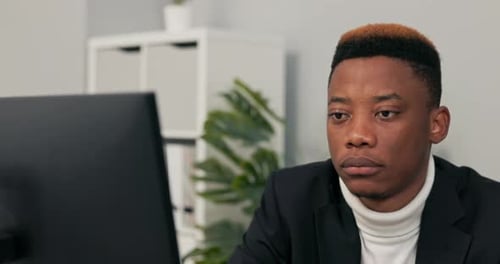 Closeup of Face of Darkskinned Man Working in an Office Law Firm Boy is Sitting Behind Desk in Front