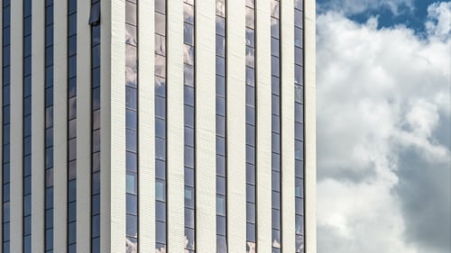 of Clouds Reflecting Onto the Glass of a Large Office Building