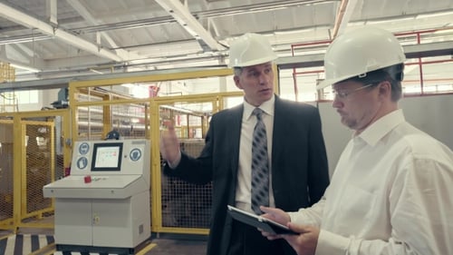 Businessman and Engineer Have a Discussion