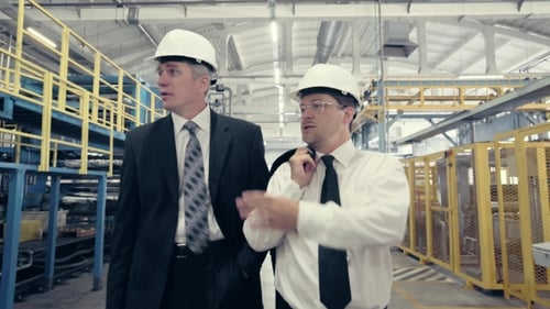 Businessmen Walking Through Factory and Talking