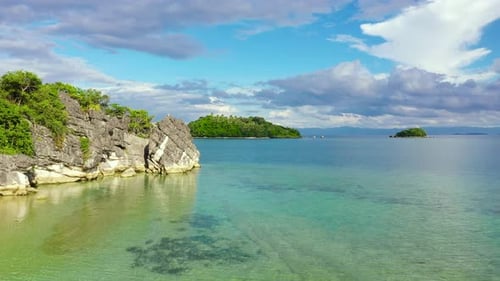 Tropical Island with a White Beach and Limestone Cliffs Aerial View