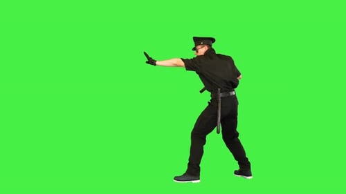 White Policeman Walks Getting the Gun Out Giving an Order on a Green Screen Chroma Key