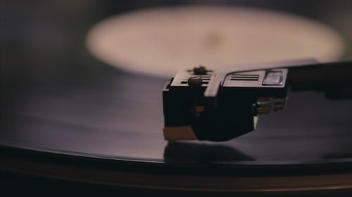Record Player Needle Playing on Vinyl