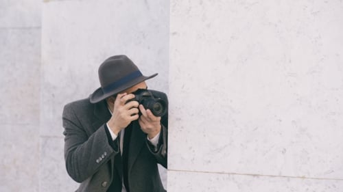 Bearded Man with Camera Behind Wall