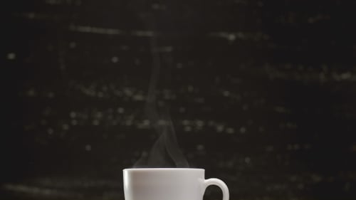 Steaming Coffee Mug with Fresh Coffee Beans