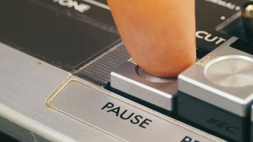 Pushing Pause Button on a Vintage Tape Recorder