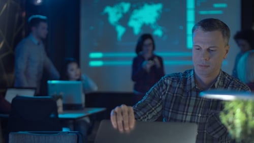 Tired Man Working Late at Office Desk