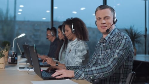 Team of Professionals Working in an Office at Night
