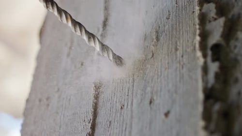 Man drilling hole in concrete wall. Repair works indoors in slow motion