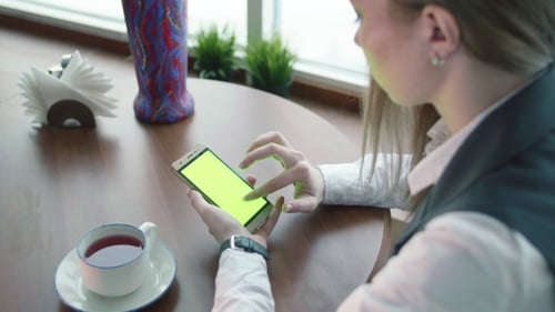 One Young Business Woman Working in Cafe with Phone Green Screen