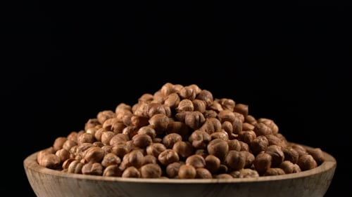 Hazelnuts Overflowing in a Rustic Wooden Bowl