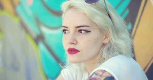 Woman with Tattoo and Piercings Posing