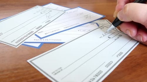 Writing a Check for Payment with a Ballpoint Pen