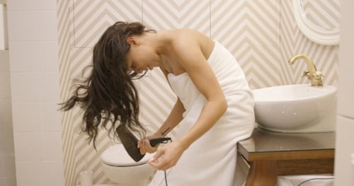 Side View of Girl Using Hair Dryer