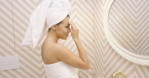 Young Female Cleaning Face