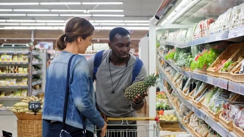 Supermarket: Happy Couple Does Shopping, Choosing Fruits and Vegetables in the Fresh Produce Section