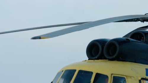 Yellow Helicopter Rotor Blades Turning on Cloudy Day
