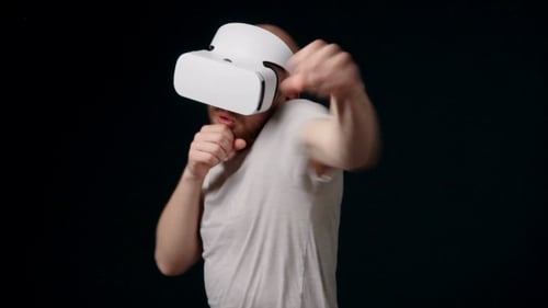 Man Boxer in Virtual Reality Headset Fights with Shadow