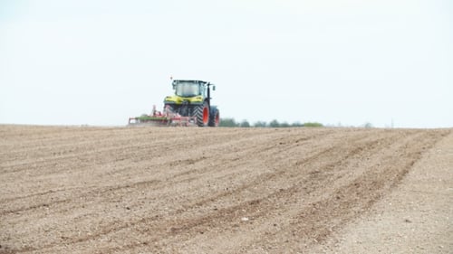Tractor Plowing Field Using Harrows