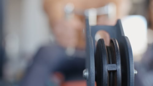 Pull Down Cable Of Crossover Machine And Doing Exercise In The Gym